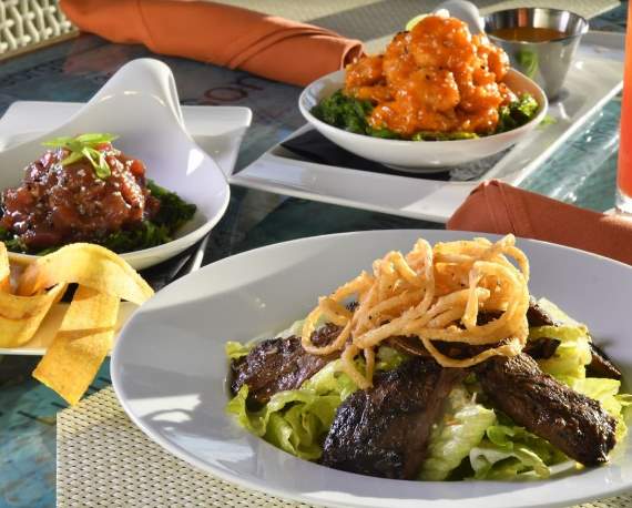 Various plates of entrées at Margaritaville Resort Orlando